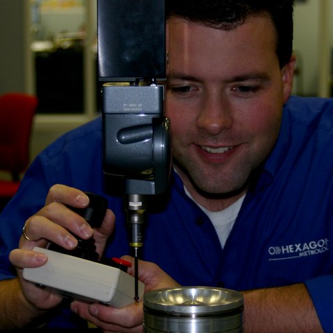 Tim Hogan operating a CMM probe head at Hexagon Metrology